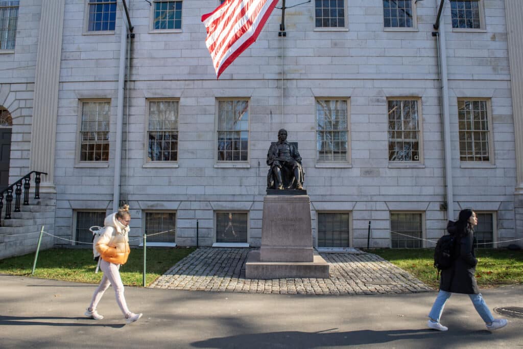 (FILES) People walk through Harvard Yard at Harvard University in Cambridge, Massachusetts, on December 12, 2023. Elite US university Harvard risked billions of dollars in federal funding on April 14, 2025 as it rejected a list of sweeping demands that the Trump administration said are intended to crack down on campus antisemitism. The call for changes to its governance, hiring practices and admissions procedures expands on a list Harvard received on April 3, which ordered officials to shut diversity offices and cooperate with immigration authorities for screenings of international students. (Photo by Joseph Prezioso / AFP)