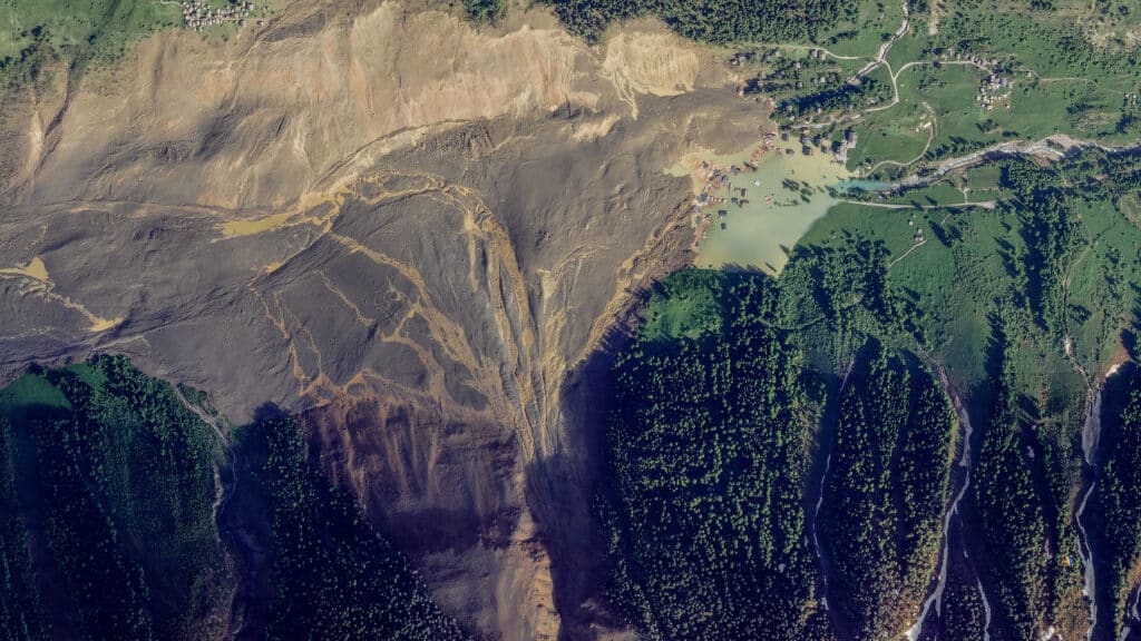 Swiss glacier collapse: Rock and ice prevent rescue work. This handout satellite image courtesy of Planet Labs PBC created on May 29, 2025, shows the small village of Blatten and its surroundings in the Bietschhorn mountain of the Swiss Alps, Switzerland on May 29, 2025 after it was destroyed the previous day by a landslide after part of the huge Birch Glacier collapsed and swallowed up by the river Lonza.| Photo by Handout / © 2025 PLANET LABS PBC / AFP